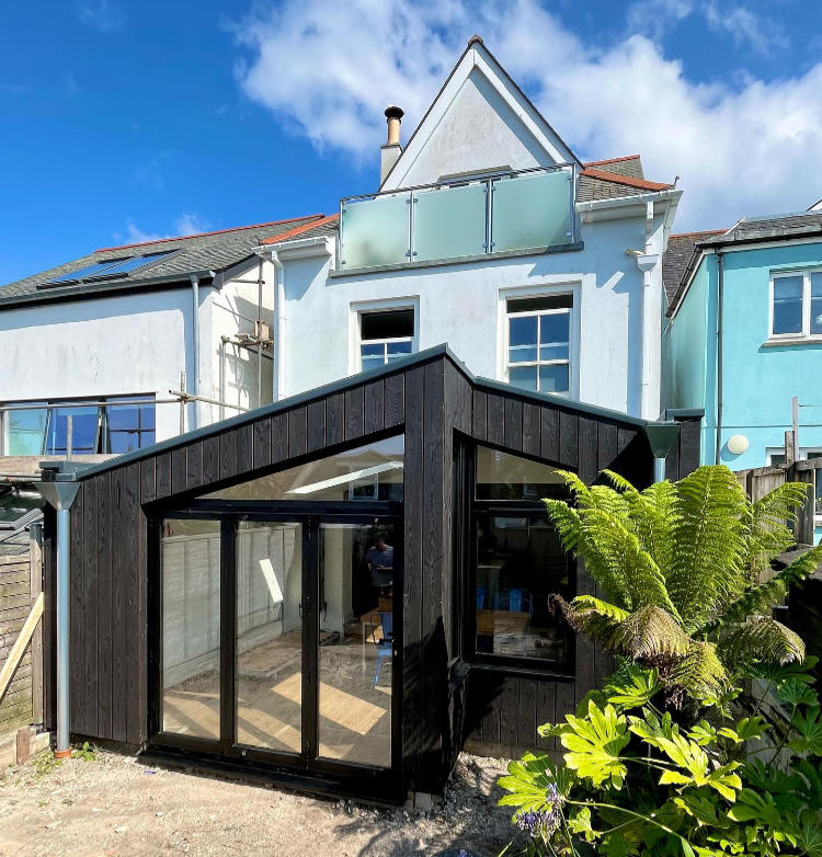 Black aluminium windows including bi-folding doors completed in Falmouth