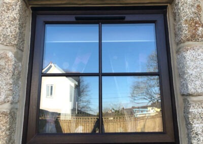 Rosewood uPVC window including astragal bar design