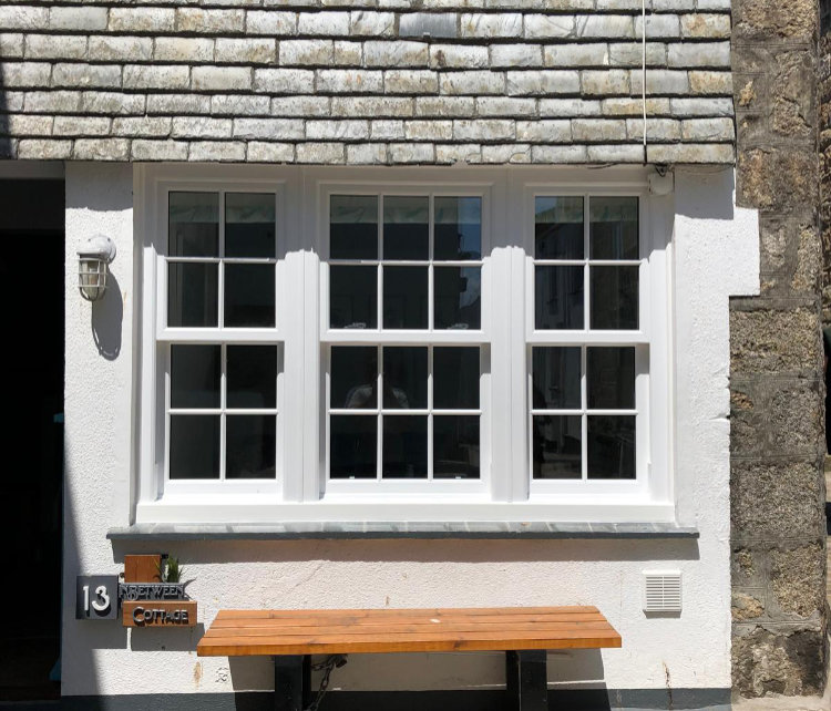 Sliding sash uPVC windows including astragal bar design to provide a traditional look in St Ives